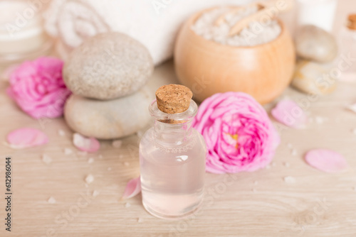 Spa composition with pink roses on wooden table