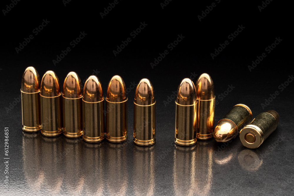 Bullet isolated on black back with reflexion. Rifle bullets close-up on black back. Cartridges for rifle and carbine on a black. Bullet isolated on black back with reflexion. Rifle bullets close-up on black back. Cartridges for rifle and carbine on a black.