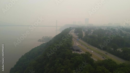 Smoky fog over Hudson River and forest with bridge in background