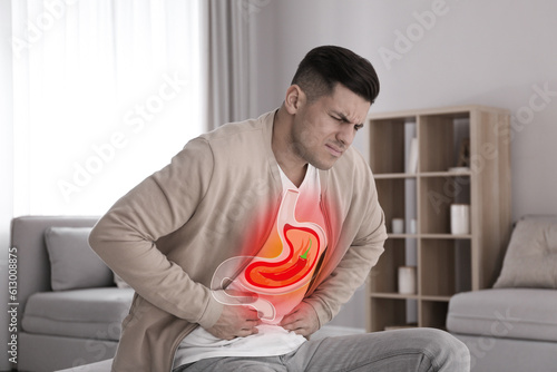 Foto Man suffering from heartburn at home
