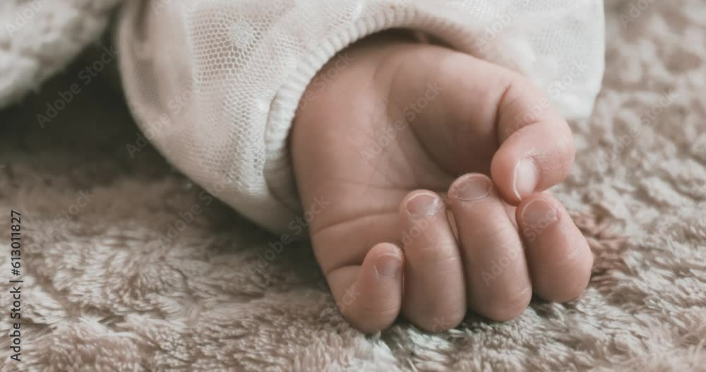 A 2x slow motion of sleeping asian baby left hand on the carpet handheld A 2x slow motion of sleeping asian baby left hand on the carpet handheld