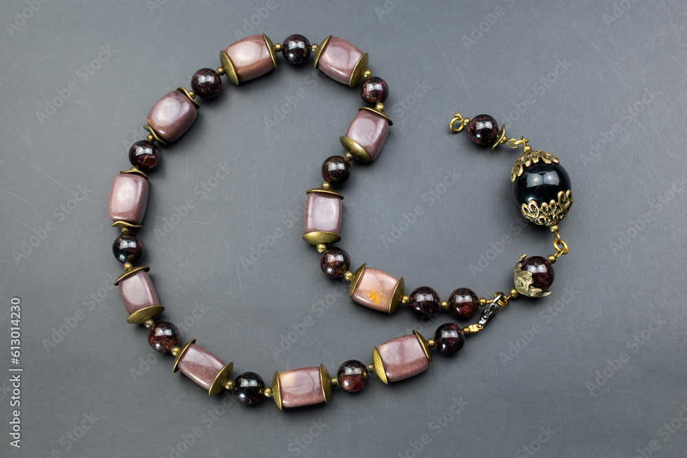 Statement stone bead necklace on a white mannequin, massive unusual handmade jewelry, promotional photo for an online jewellery store Statement stone bead necklace on a white mannequin, massive unusual handmade jewelry, promotional photo for an online jewellery store