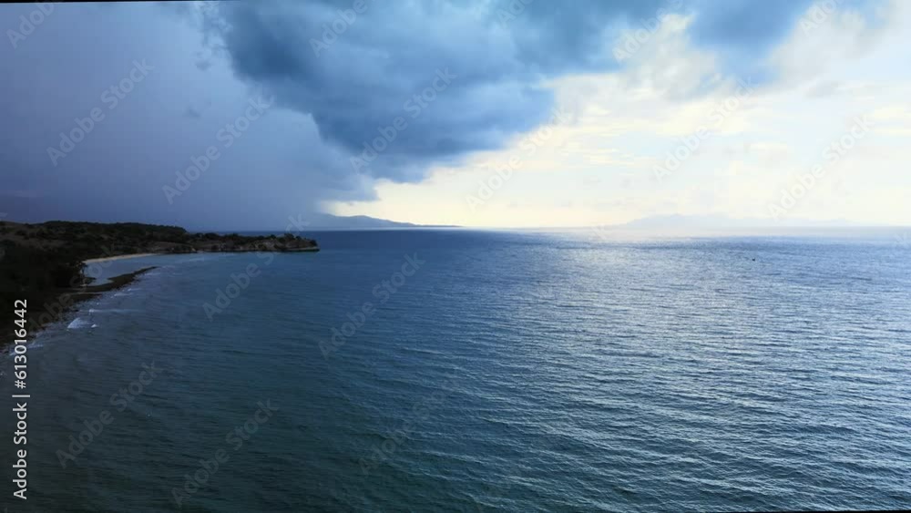 The blue colored sea water with a land on the left side The blue colored sea water with a land on the left side