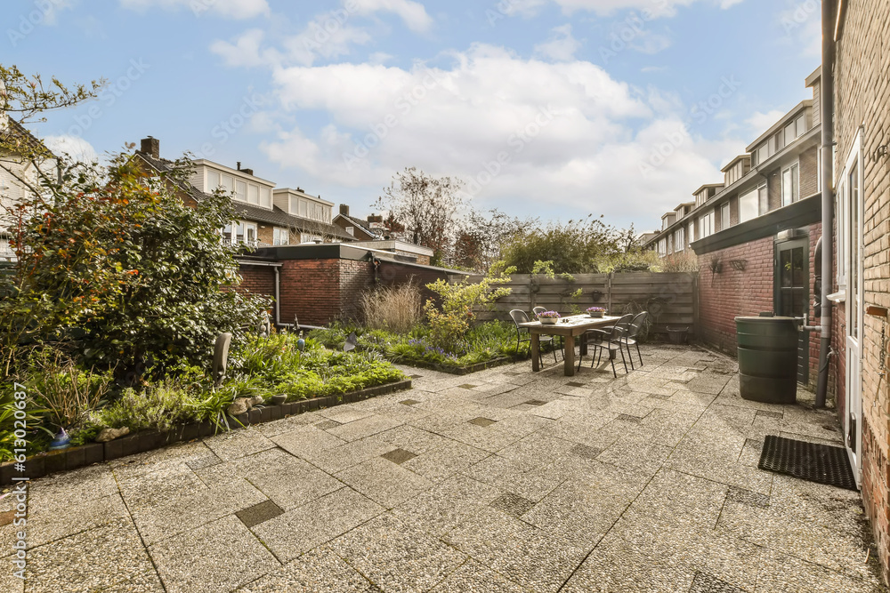 an empty backyard with graveled ground and trees in the fore - image is taken from outside, looking towards the back garden an empty backyard with graveled ground and trees in the fore - image is taken from outside, looking towards the back garden