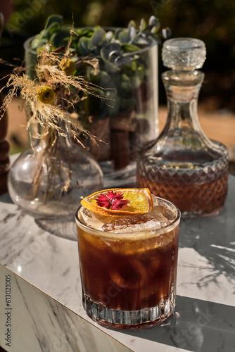 Sparkling Espresso Delight: Shaken Carajillo Cocktail with Dehydrated Orange and Edible Flowers