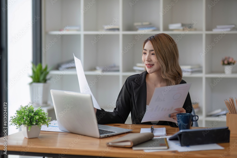 Asian businesswoman working in the office with working documents. Asian businesswoman working in the office with working documents.