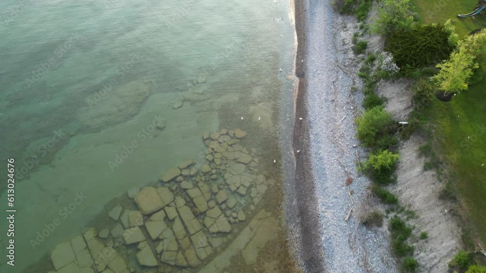 Aerial Drone View of Lake Ontario's Rocky Coast during Sunset hours (Cobourg, Ontario, Canada) Aerial Drone View of Lake Ontario's Rocky Coast during Sunset hours (Cobourg, Ontario, Canada)
