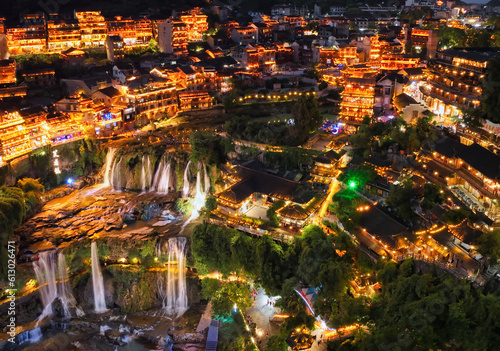 Beautiful ancient town in China with waterfall and traditional houses at night