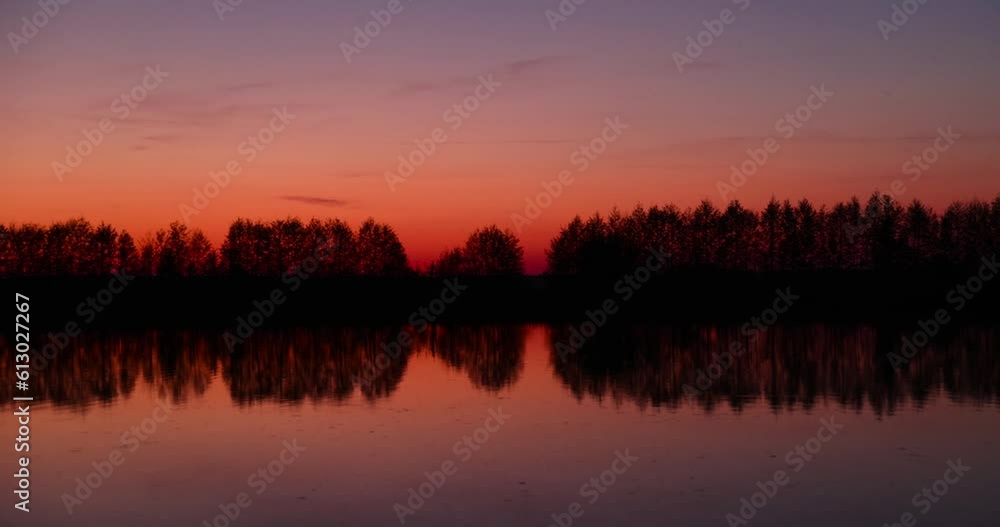 beautiful orange-yellow sunset on the lake in spring, the sun illuminates the lake with yellow-orange color at sunset beautiful orange-yellow sunset on the lake in spring, the sun illuminates the lake with yellow-orange color at sunset