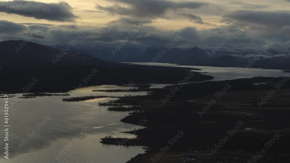 Cloudy Evening Sky Over Lake In Swedish Lapland Near Kebnekaise Mountain At Dusk. wide aerial Cloudy Evening Sky Over Lake In Swedish Lapland Near Kebnekaise Mountain At Dusk. wide aerial