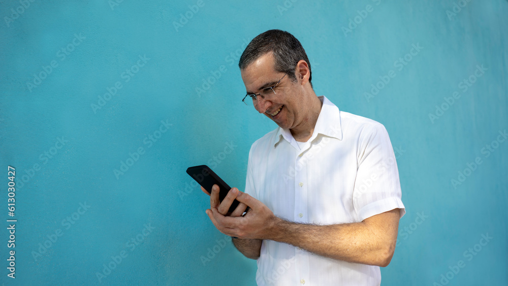 a man accessing his smartphone and happy a man accessing his smartphone and happy