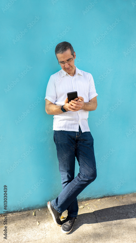 a man accessing his smartphone and happy a man accessing his smartphone and happy