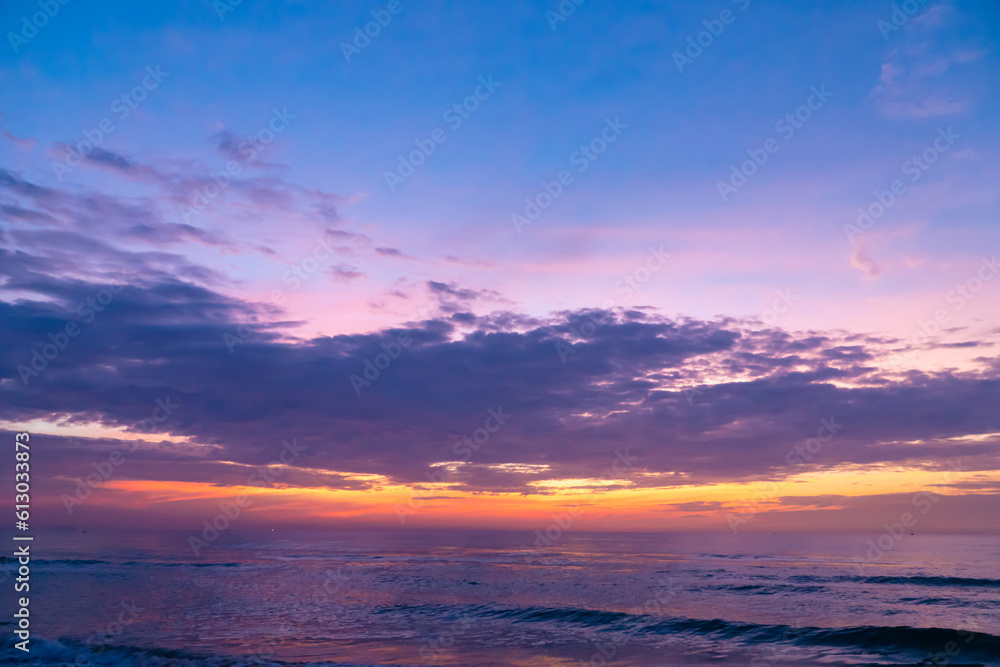 The landscape of the sunrise is brilliantly bright over the colorful sea, with the sky and the brilliant clouds. Sea style sunrise and sunset.