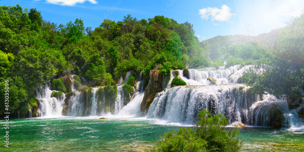 Obraz premium Beautiful Waterfall background in sunny summer day. Beautiful Waterfall In Krka National Park - Croatia, Europe. Krka river waterfalls in the Krka National Park