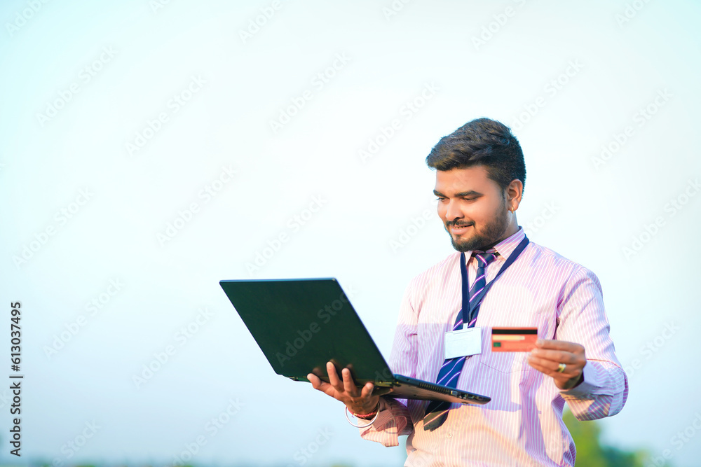 Indian Banker (agronomist) with farm field Indian Banker (agronomist) with farm field