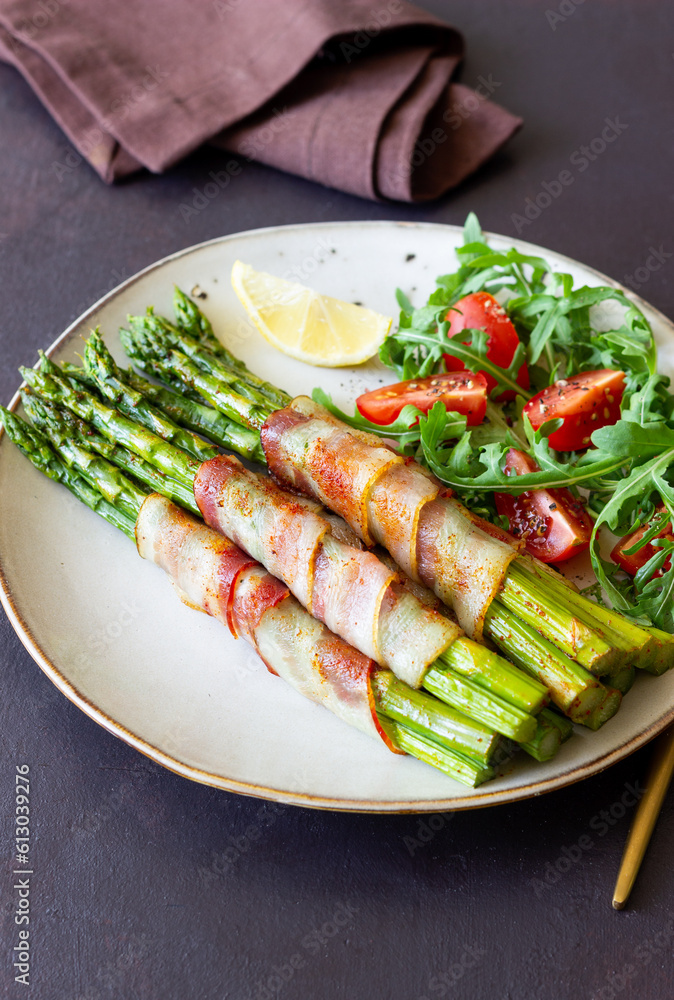 Asparagus baked with bacon and arugula and tomato salad. Healthy eating. Diet. Asparagus baked with bacon and arugula and tomato salad. Healthy eating. Diet.