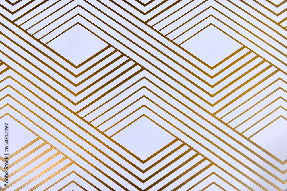Shiny gold geometric lines on white paper top down view Shiny gold geometric lines on white paper top down view