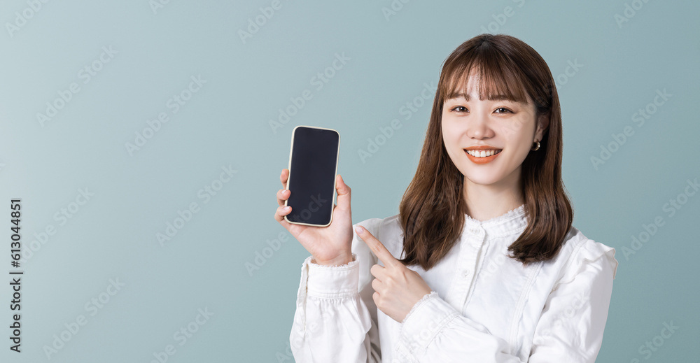 スマホを指差す笑顔のビジネスウーマン スマホを指差す笑顔のビジネスウーマン