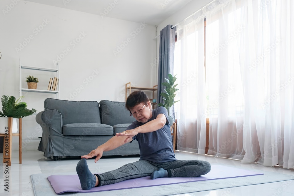 Middle age woman smiling happy doing exercise and stretching in living room at home