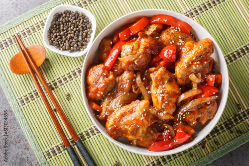 Black Pepper chicken, is a fast, easy stir-fry made with chicken, onions, and peppers seasoned with oyster sauce and loads of black pepper closeup. Horizontal top view from above