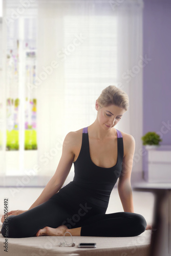 Portrait of beautiful young woman in sportswear doing yoga stretching, it and flexible young woman performing a stretching gymnastic exercise.