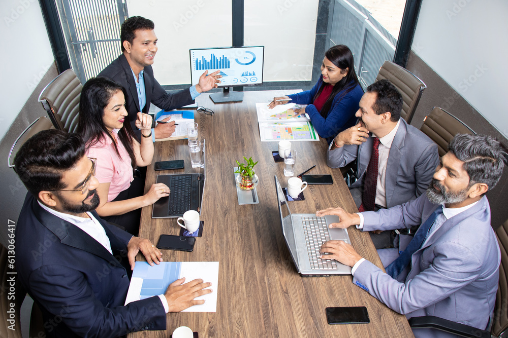 Φωτογραφία Indian business people meeting presentation in office conference room showing Charts Infographics on TV screen to show growth of company and big data analysis