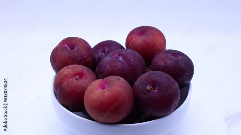 Fresh plums in a bowl isolated on white background Fresh plums in a bowl isolated on white background