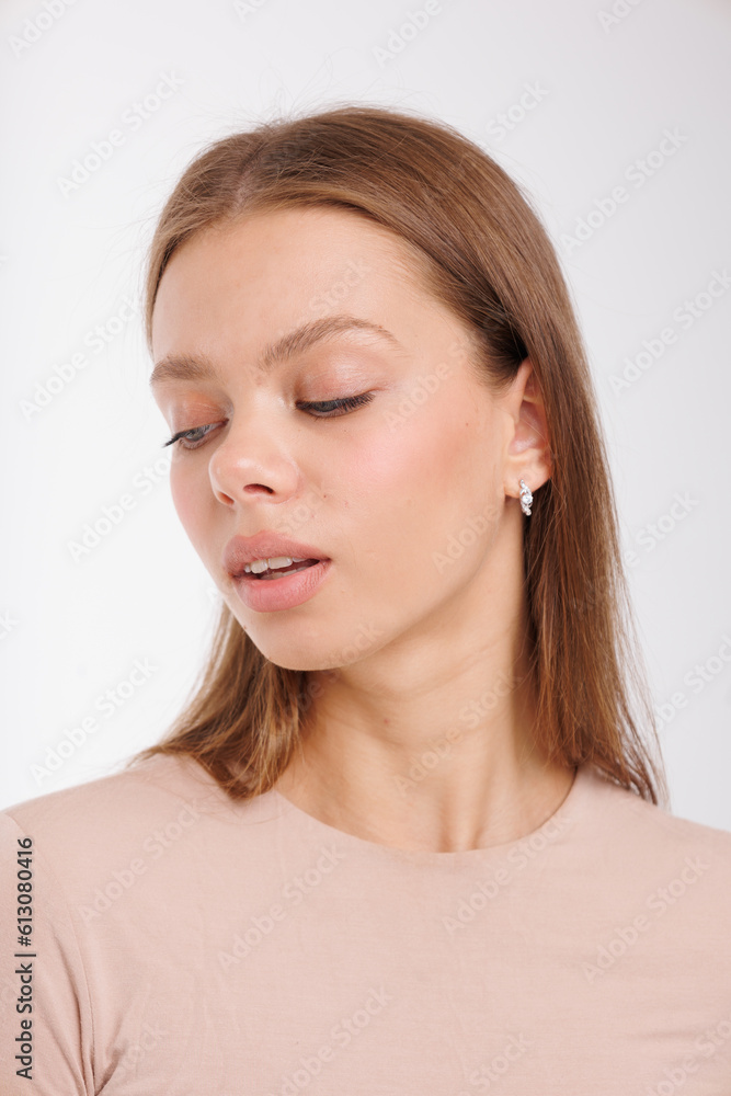 Beautiful young girl with fresh healthy skin. Woman advertise ear-rings. White background. Earrings closeup. Blond european woman with long hair with big lips, pretty smile. Cosmetology, scincare Beautiful young girl with fresh healthy skin. Woman advertise ear-rings. White background. Earrings closeup. Blond european woman with long hair with big lips, pretty smile. Cosmetology, scincare