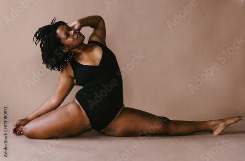Female black dancer in half split yoga pose with stretch photo