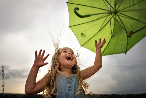 Little girl with umbrella and big smile