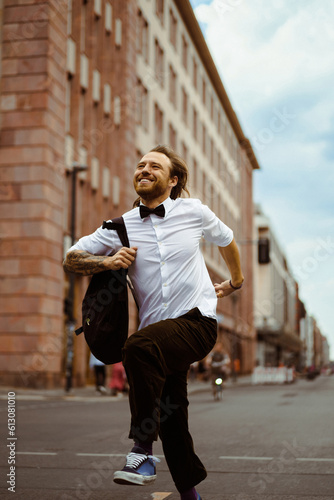 Man in white shirt and bow tie, hurry in the city, urban rhythm.
