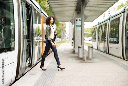 Young confident and relaxed woman commuting in city tram. photo