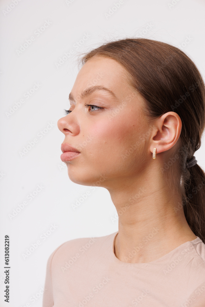 Beautiful young girl with fresh healthy skin. Woman advertise ear-rings. White background. Earrings closeup. Blond european woman with long hair with big lips, pretty smile. Cosmetology, scincare Beautiful young girl with fresh healthy skin. Woman advertise ear-rings. White background. Earrings closeup. Blond european woman with long hair with big lips, pretty smile. Cosmetology, scincare