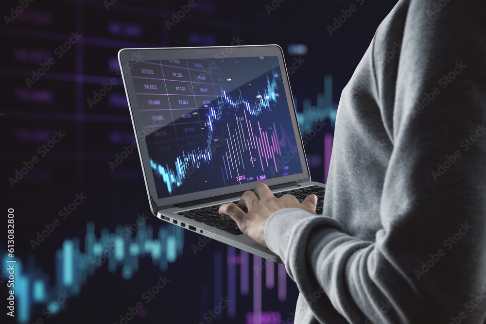Close up of hands using laptop with glowing candlestick forex chart on blurry background. Investment, profit and financial growth concept. Double exposure. Close up of hands using laptop with glowing candlestick forex chart on blurry background. Investment, profit and financial growth concept. Double exposure.