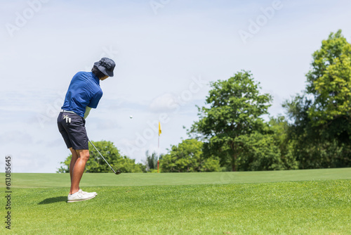 Canvas Print Golfers chipping a golf ball onto the green.