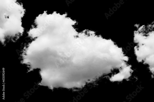 white fluffy clouds standing out against a black background and a blue sky