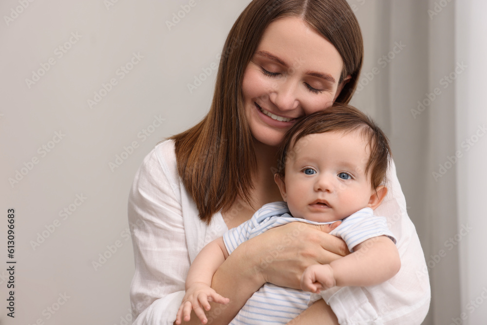 Happy mother with her little baby indoors Happy mother with her little baby indoors