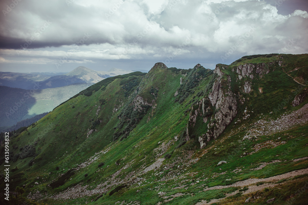 A breathtaking panorama of the majestic Carpathian Mountains in Ukraine, showcasing rugged peaks, lush green valleys, and expansive skies A breathtaking panorama of the majestic Carpathian Mountains in Ukraine, showcasing rugged peaks, lush green valleys, and expansive skies