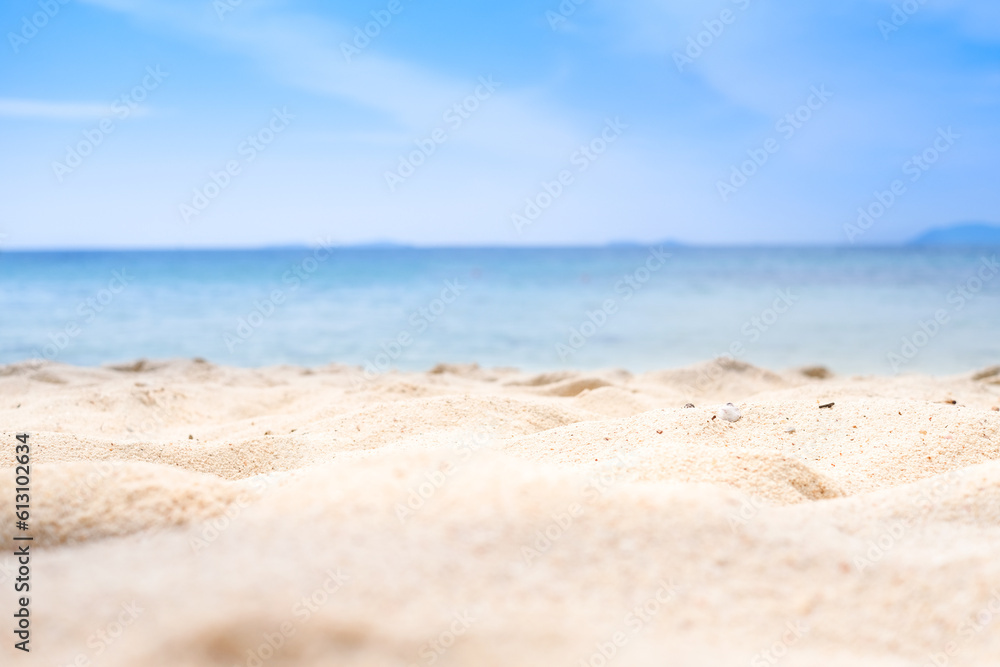 Beach sand background for summer vacation concept. Beach nature and summer seawater with sunlight light sandy beach Sparkling sea water contrast with the blue sky.	