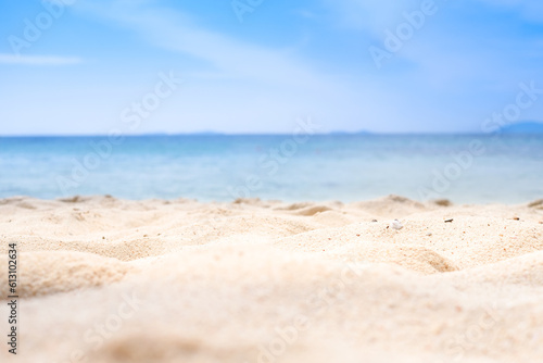 Beach sand background for summer vacation concept. Beach nature and summer seawater with sunlight light sandy beach Sparkling sea water contrast with the blue sky. 