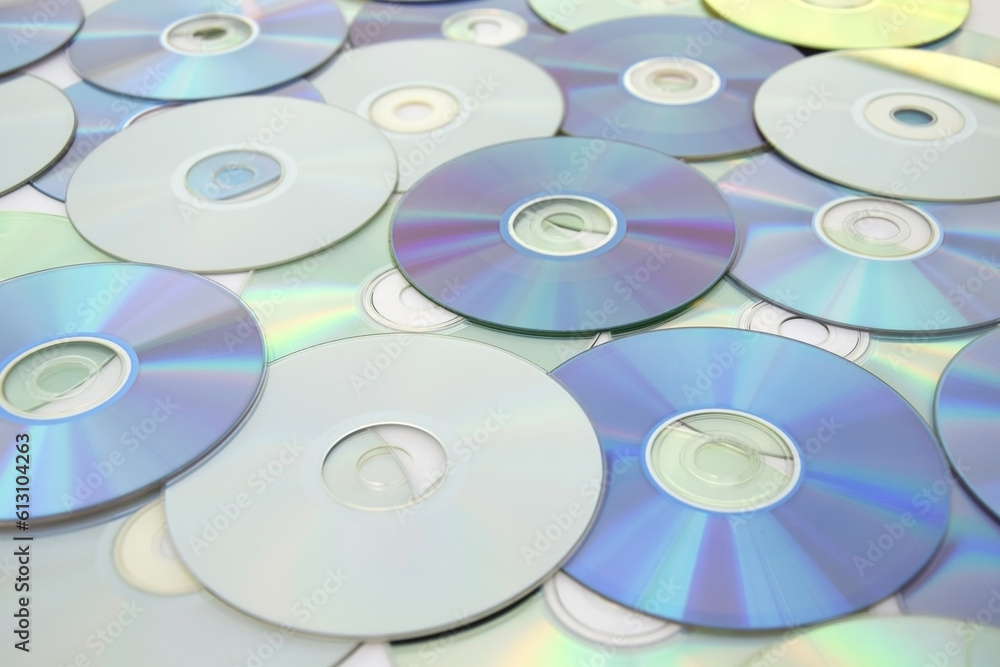 Lots of old CDs are laid out as a background. Lots of old CDs are laid out as a background.