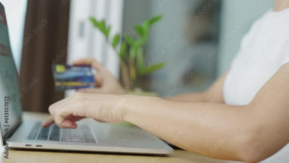woman hand holding credit card and using laptop for online shopping while making order at home. Marketplace platform website, technology, ecommerce, digital banking and online payment concept woman hand holding credit card and using laptop for online shopping while making order at home. Marketplace platform website, technology, ecommerce, digital banking and online payment concept