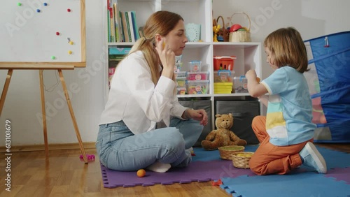 A compassionate therapist guides a child towards confident speech and language skills, blending fun and education in private tutoring sessions tailored to the child's needs