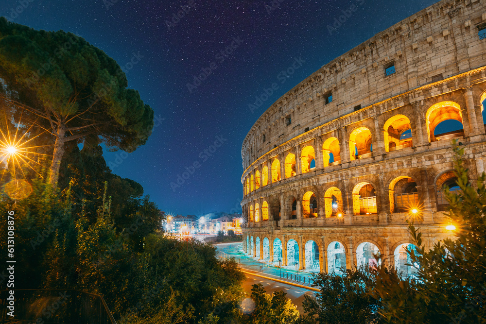 Rome, Italy. Amazing Bold Bright Dark Blue Night Starry Sky With Glowing Stars Above Colosseum Also Known As Flavian Amphitheatre In Evening Or Night Time. Spirit Of Travel.