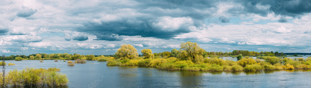 Panoramic View Countryside Landscape During Spring Flood Floodwaters. Tranquil Bold Bright Blue Sky Above Nature Landscape During Spring Flood. Amazing Reflections In River. Musical Calmness Concept.