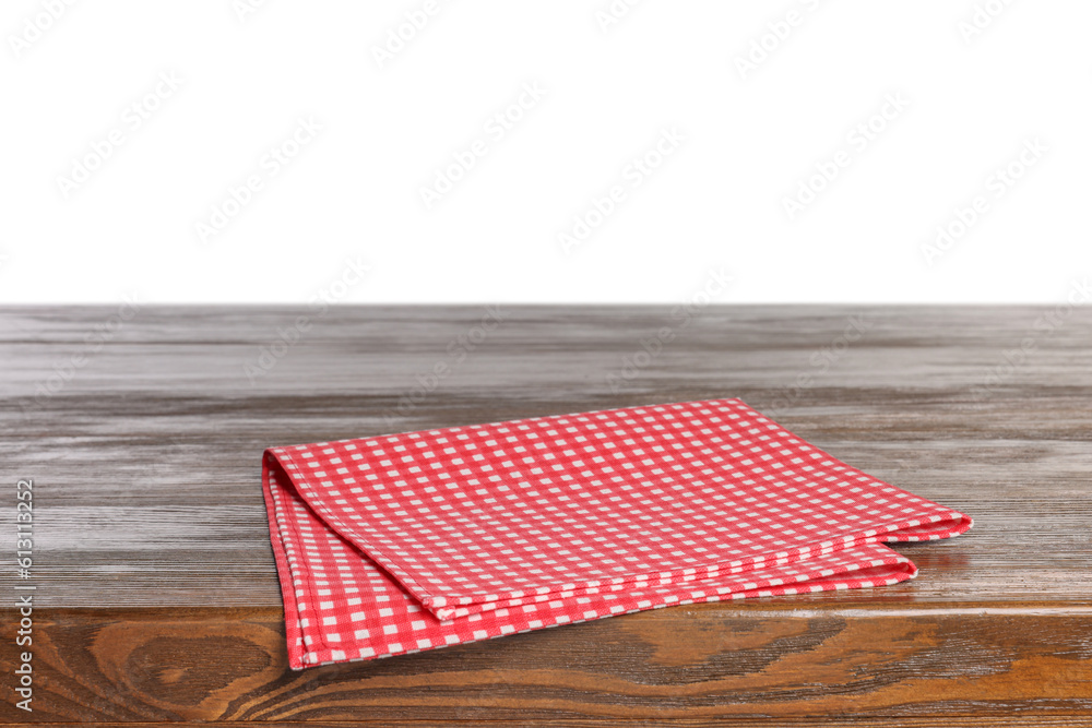 Checkered tablecloth on wooden table against white background Checkered tablecloth on wooden table against white background