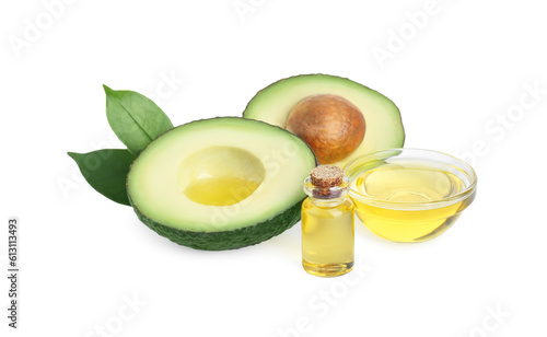 Essential oil and cut avocado on white background