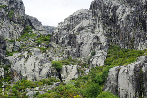 Landscape with rocky cliffs covered by green bushes of Serra da Estrela, Portugal 
