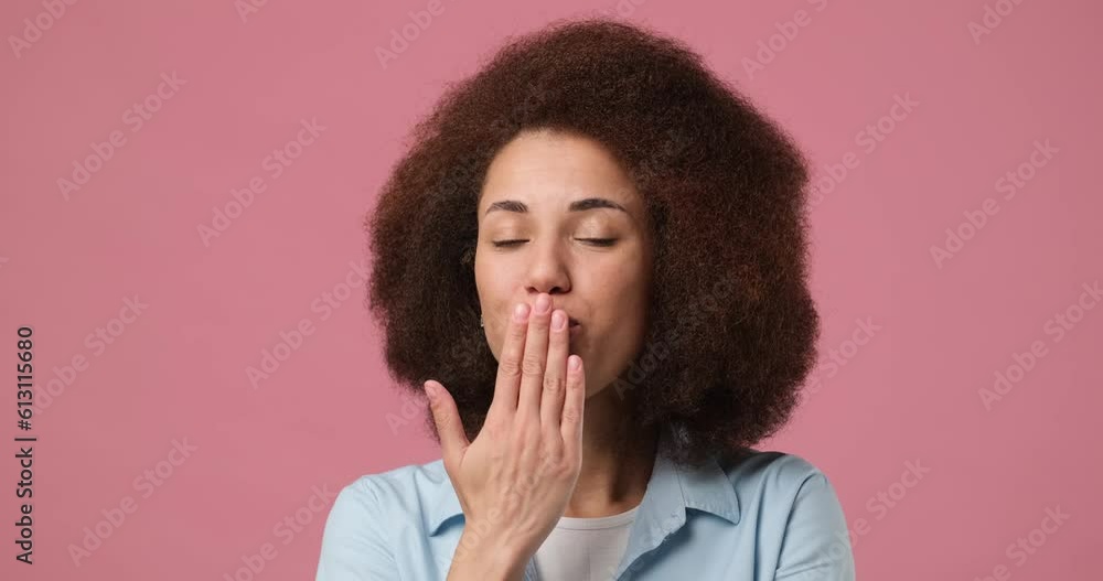 Young african american woman smiling confident blowing kiss isolated pink studio background Young african american woman smiling confident blowing kiss isolated pink studio background