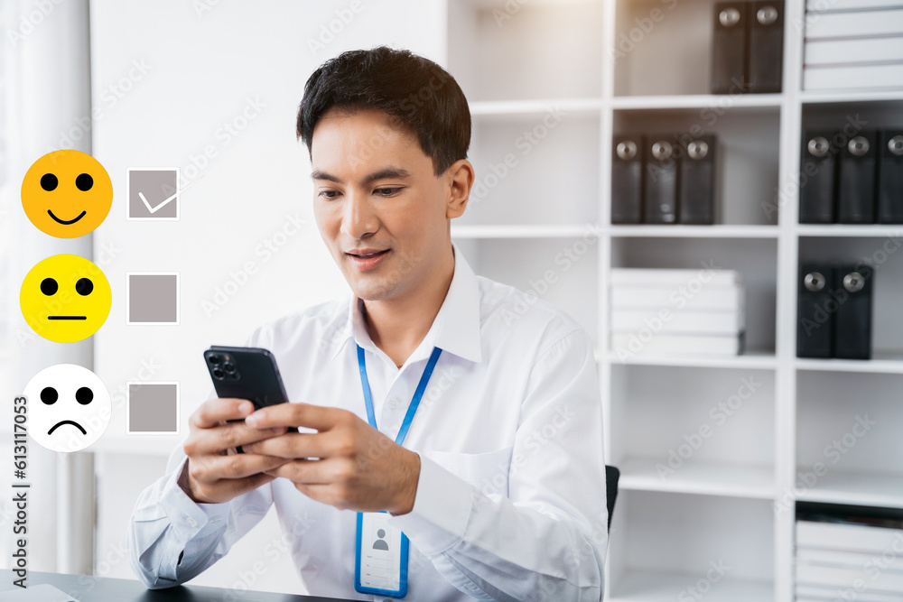 Male businessman holding a digital smartphone with checkboxes rating smiley faces excellent for Satisfaction Survey, Happy Client Customer Experience concept. Male businessman holding a digital smartphone with checkboxes rating smiley faces excellent for Satisfaction Survey, Happy Client Customer Experience concept.
